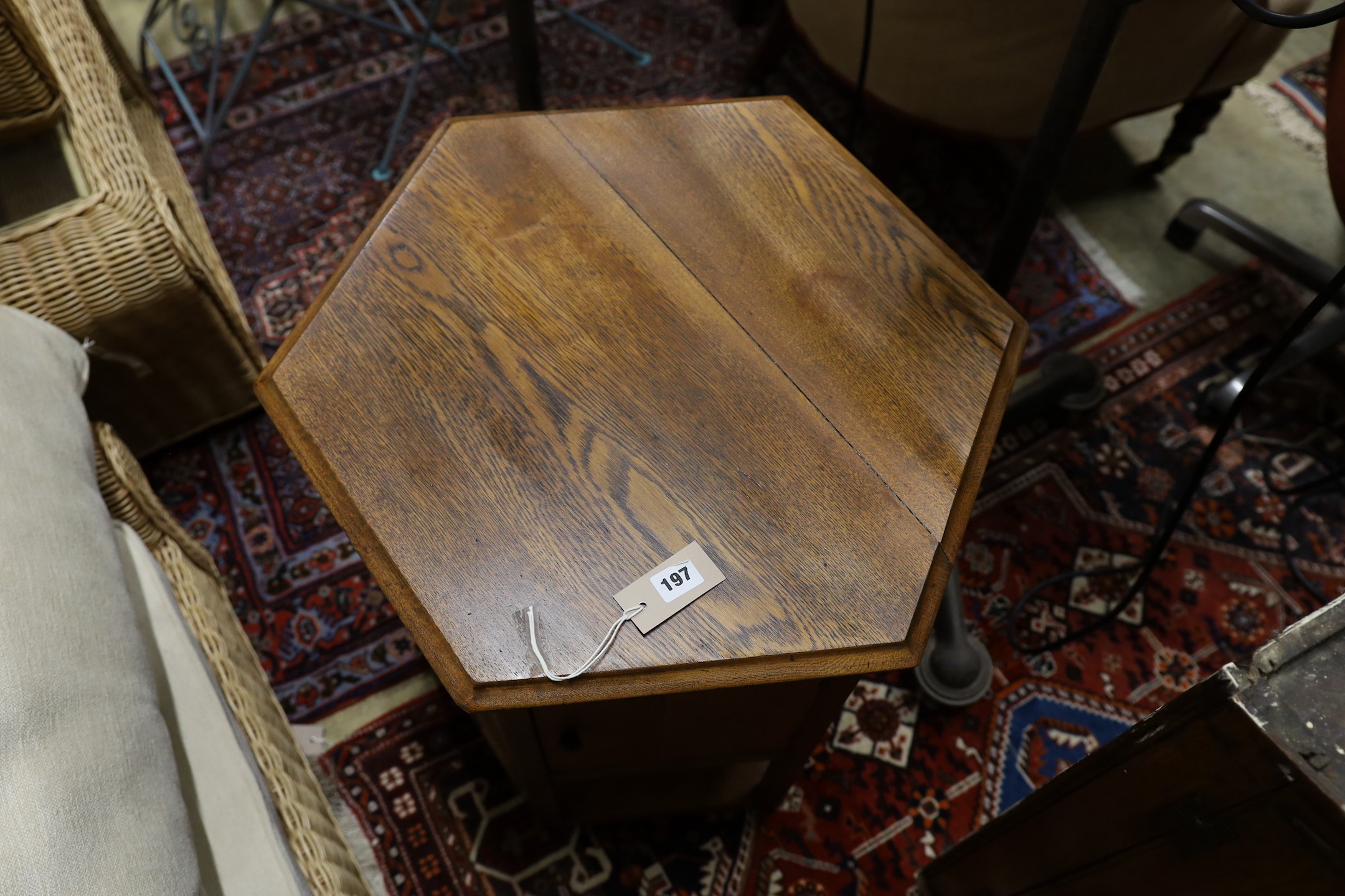 A mid 20th century hexagonal oak revolving cabinet, width 53cm, height 53cm